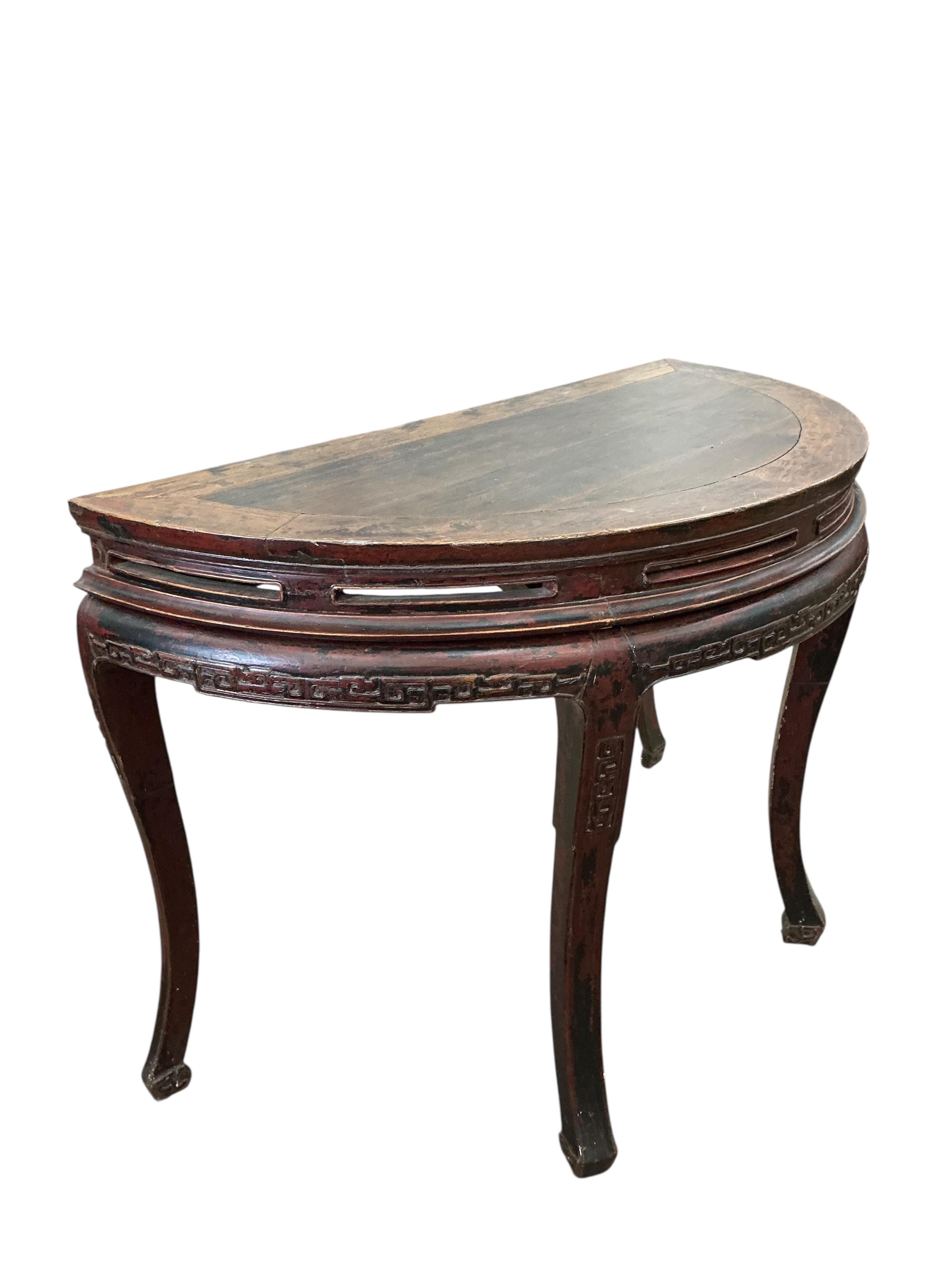 A pair of Chinese part lacquered demi lune console tables, width 124cm, depth 63cm, height 90cm